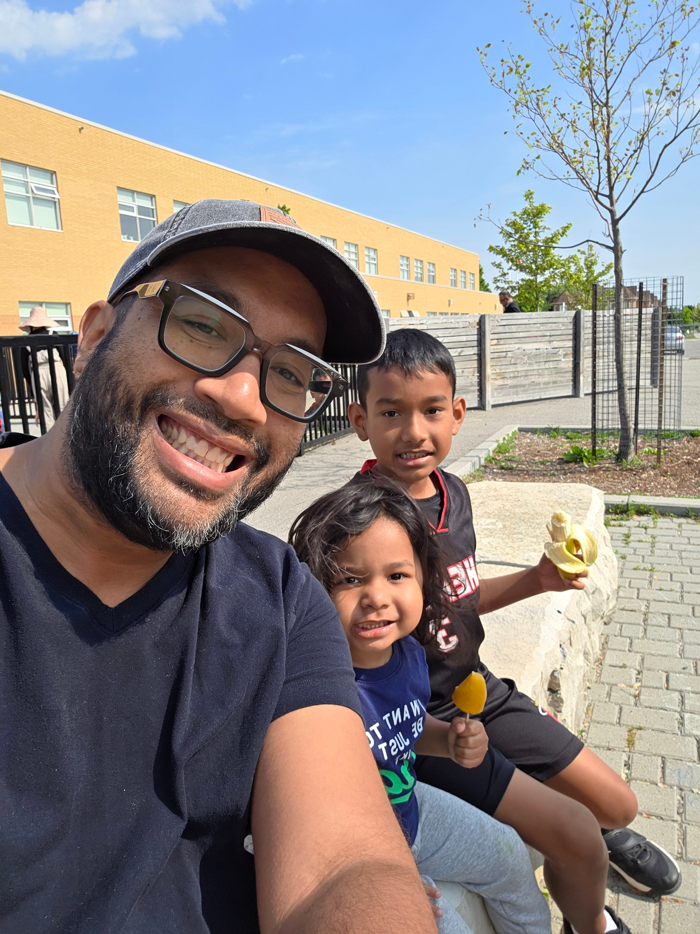 Dr. Andre De Freitas with his two sons outside a Pickering school